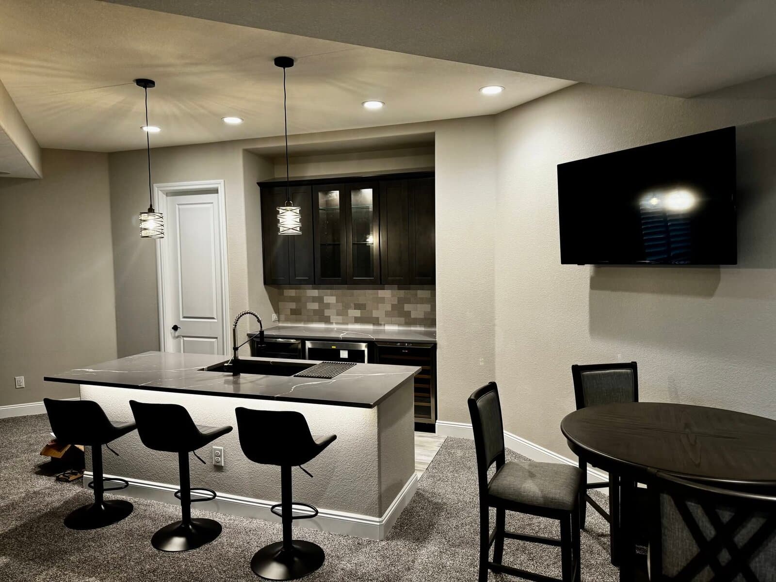 Finished basement bar and entertainment area by JH Basement Finish